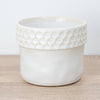 A captivating Zellige Ceramic White Plant Pot - admired for their tactile divot arch rims and minimalist style.